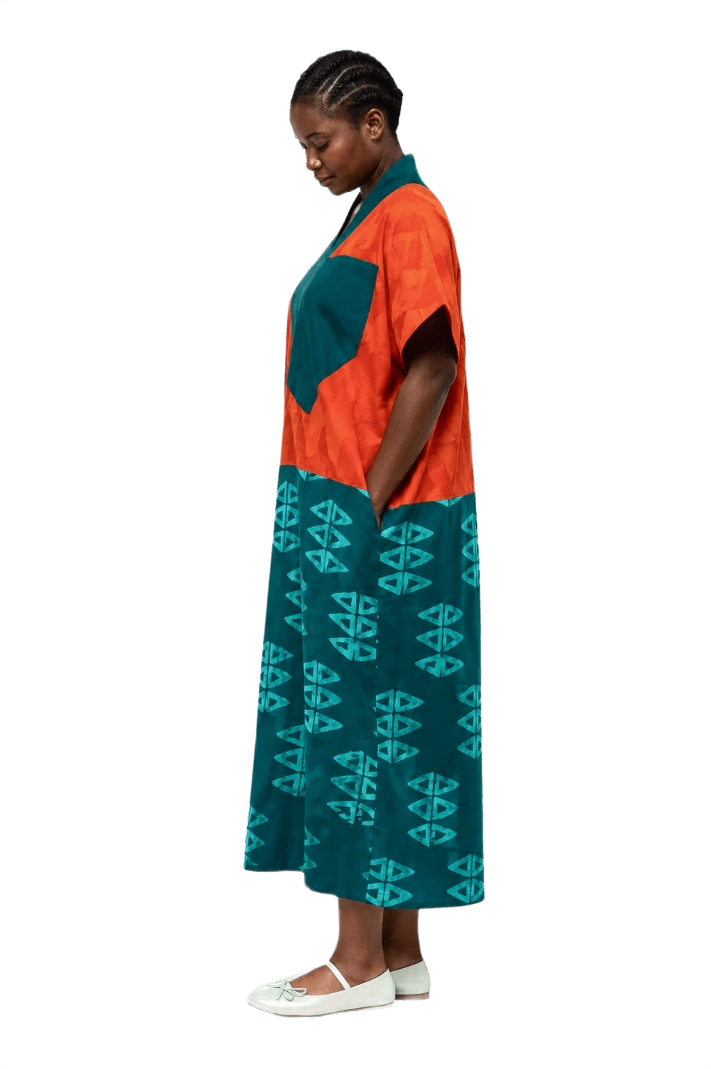 Orange and teal Adire bubu, worn in profile